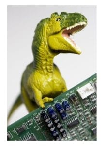 Toy t-rex dinosaur holding a circuit board