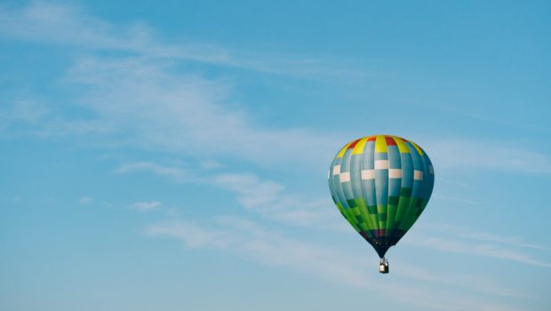 Passenger balloon floating in blue sky
