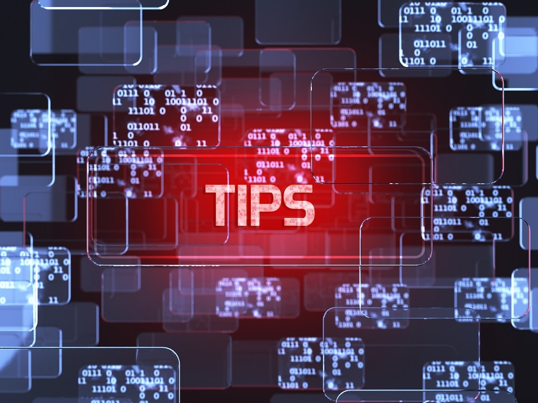 Tips in bright neon red letters on a dark background with touchscreens.